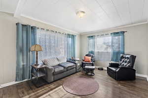 Living room featuring beam ceiling, hardwood / wood-style flooring, and crown molding ADU