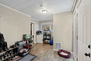 Interior space featuring hardwood / wood-style floors and ornamental molding