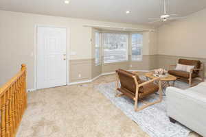 Living room featuring ceiling fan and light colored carpet