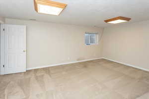 Family room featuring carpet floors and a textured ceiling