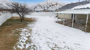 Snowy yard with a mountain view