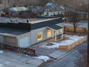 View of snowy exterior featuring a garage