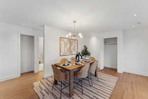 Dining room featuring light hardwood / wood-style floors and an inviting chandelier