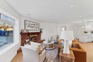 Living room featuring light hardwood / wood-style flooring and a fireplace