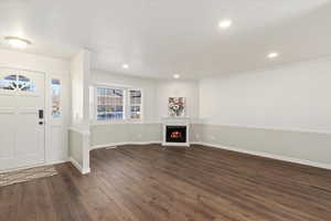 Entryway featuring crown molding and dark hardwood / wood-style floors