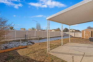 View of yard with a patio and a storage shed