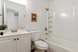 Full bathroom featuring shower / bathing tub combination, vanity, and toilet