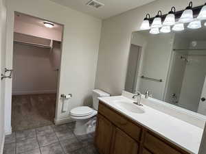 Full bathroom featuring vanity, toilet, bathtub / shower combination, and tile patterned floors