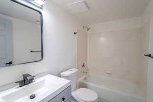 Full bathroom featuring vanity, toilet, and shower / washtub combination