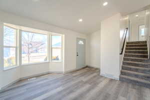 Entrance foyer featuring a wealth of natural light and light wood-type flooring