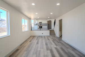 Unfurnished living room with a textured ceiling and light hardwood / wood-style flooring