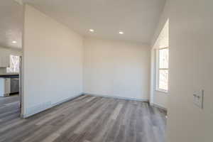 Empty room featuring hardwood / wood-style flooring, a textured ceiling, and a wealth of natural light