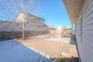 Snowy yard with a patio