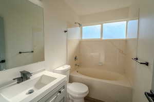 Full bathroom featuring vanity, toilet, and shower / bath combination