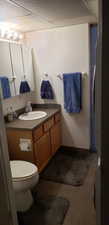 Bathroom featuring vanity, toilet, and tile patterned flooring