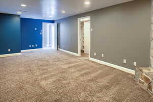 Spare room featuring a textured ceiling and carpet floors