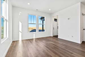 Unfurnished room with dark hardwood / wood-style floors