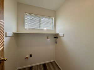 Washroom with hardwood / wood-style floors and hookup for an electric dryer