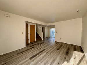 Unfurnished room featuring a textured ceiling and wood-type flooring