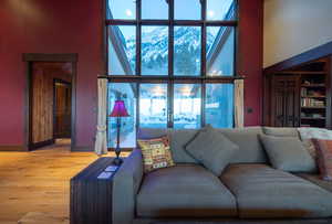 Living room featuring a towering ceiling and hardwood / wood-style floors