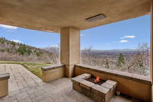 View of patio / terrace with an outdoor fire pit and a mountain view