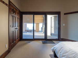 Carpeted bedroom featuring access to exterior