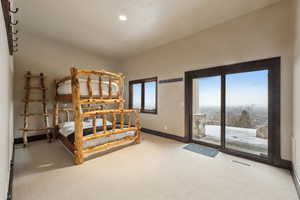 Bedroom with carpet floors and access to outside