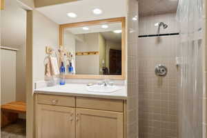 Bathroom featuring vanity and a tile shower