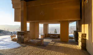 Snow covered patio with a mountain view