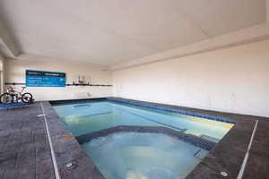 View of pool with an indoor in ground hot tub