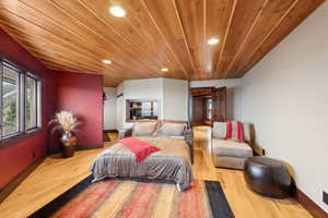 Bedroom featuring light wood-type flooring and wood ceiling