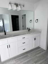 Bathroom featuring vanity and wood-type flooring