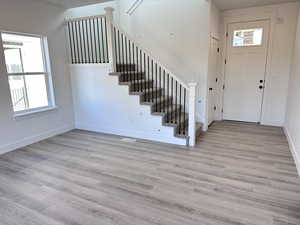 Entrance foyer featuring light hardwood / wood-style floors