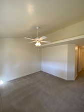 Primary bedroom featuring lofted ceiling and ceiling fan