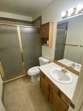 Bathroom with toilet, walk in shower, and vanity