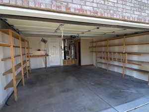 Garage with a garage door opener and gas water heater