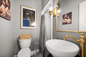 Bathroom featuring sink and toilet