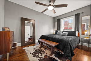 Bedroom with ceiling fan and dark hardwood / wood-style floors