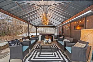 View of patio / terrace featuring an outdoor hangout area, a gazebo, and a hot tub