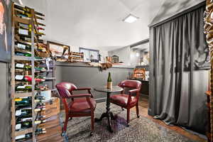 Wine room with hardwood / wood-style floors