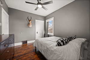 Bedroom featuring ceiling fan and dark wood-type flooring