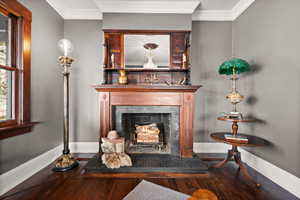 Interior space featuring crown molding and dark hardwood / wood-style floors