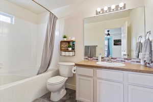 Full bathroom featuring vanity, toilet, and shower / bath combo