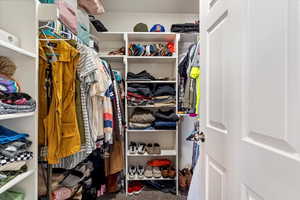 Spacious closet with carpet floors