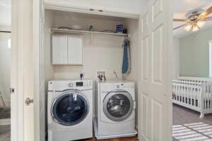 Laundry area with cabinets, separate washer and dryer