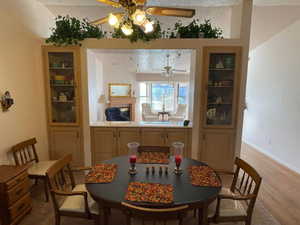 Dining room with ceiling fan, built in features, a textured ceiling, and light hardwood / wood-style flooring