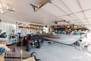 Garage with a garage door opener and ceiling fan