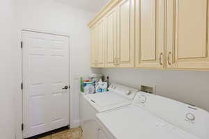 Laundry area with cabinets and independent washer and dryer