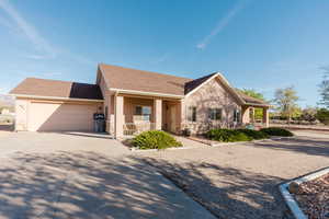 View of front of home featuring covered porch and a garage