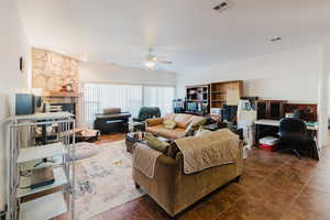 Living room with ceiling fan and a fireplace